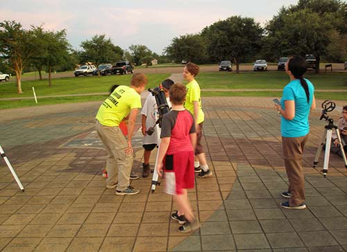 children observing through telescope at McNair outreach
