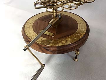 Walnut base, handle and chapter ring engraved with weeks, seasons, and zodiac