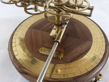 Walnut base, handle and chapter ring engraved with weeks, season and zodiac