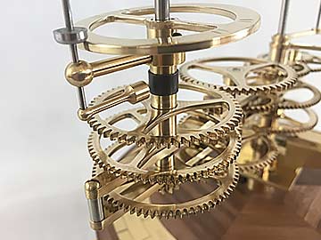 The moon arm is attracted to the centre of the column by way of a  magnet insuring that the moon remains constantly facing towards Earth