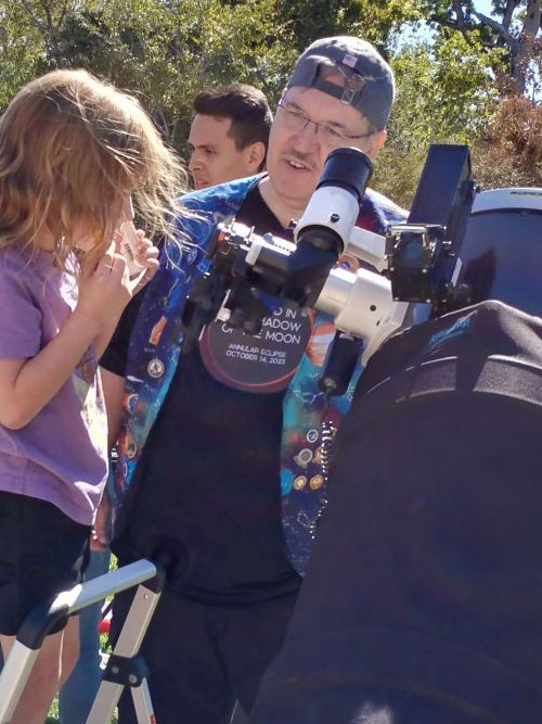 Young observer looks through Tom's telescope