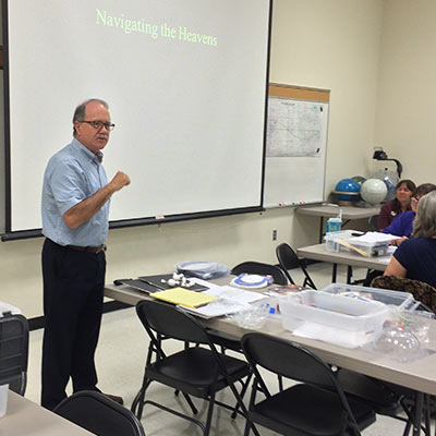 Spearman presenting astronomy lesson for teachers on staff development day