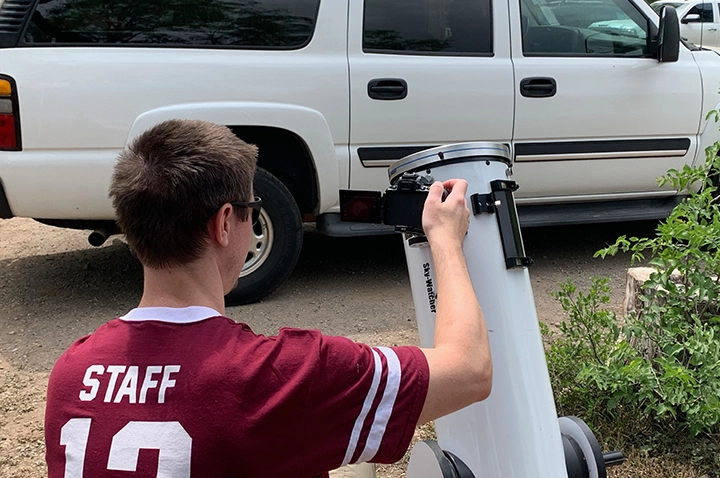 Matthew Barry guides his telescope to follow the eclipse