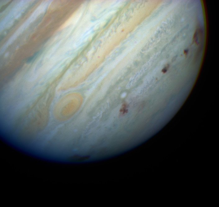 Comet P/Shoemaker-Levy 9 makes several impact marks on Jupiter