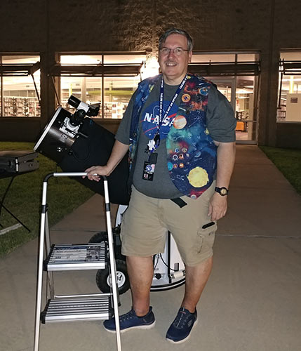 Tom Campbell outreach coordinator standing with his telescope